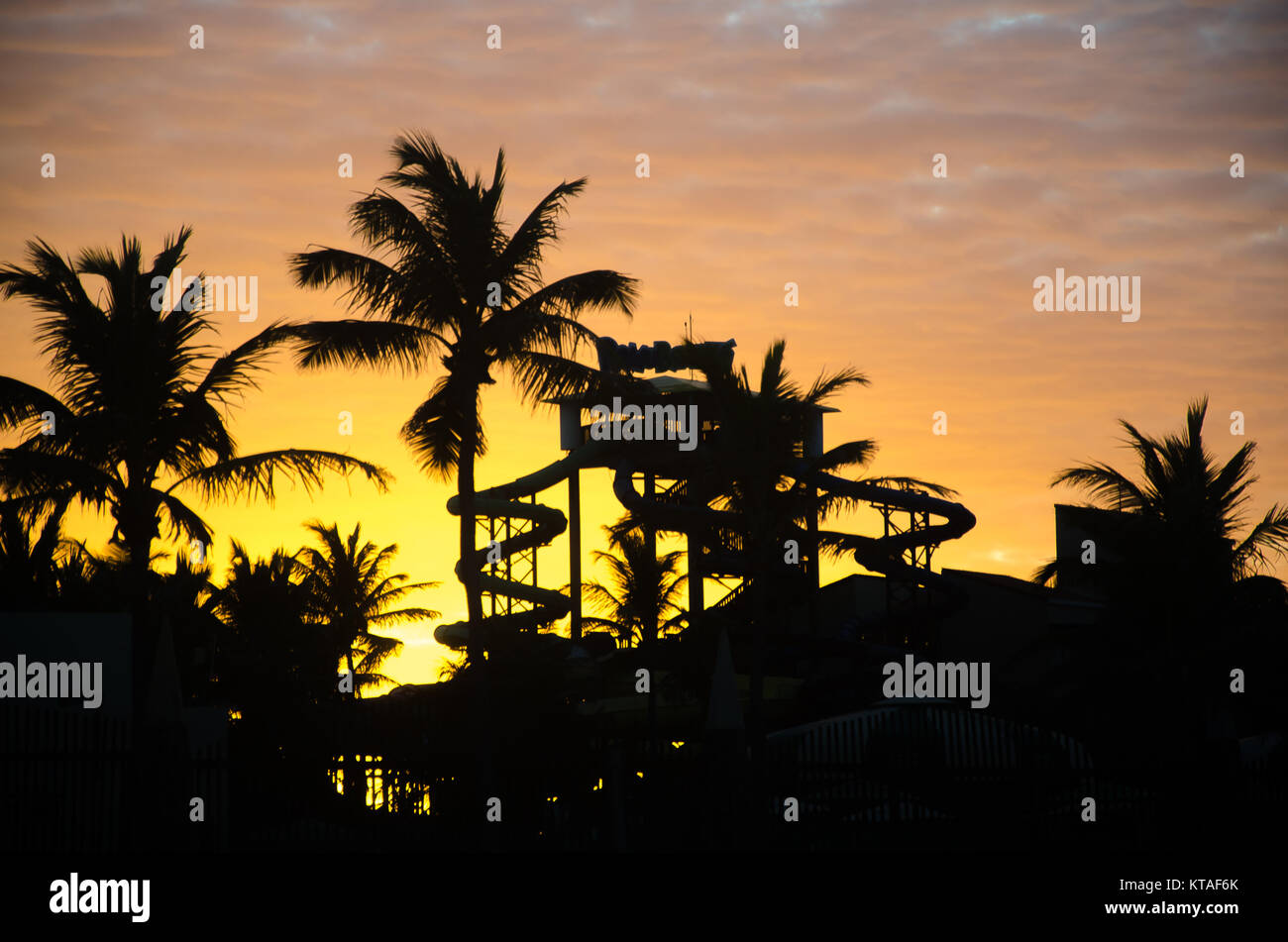 Fortaleza, Brazil, jul 8, 2017: Sunset golden hour with colored sky,  palm trees and aquatic park as background Stock Photo