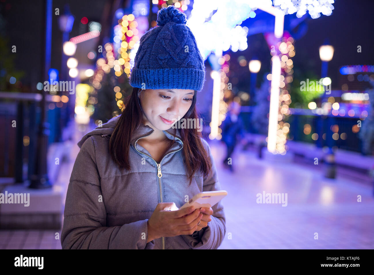 Woman using mobile phone at night Stock Photo - Alamy