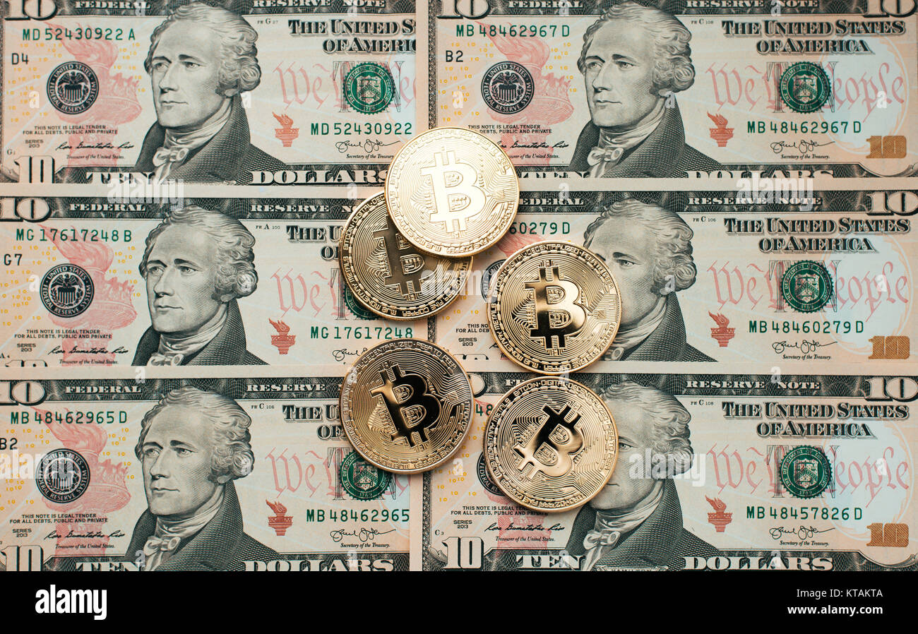 Coins bitcoin, there are money, on the table a note of 10 dollars. The banknotes are spread out on the table in a loose order of 10 dollars. Gold coin Stock Photo