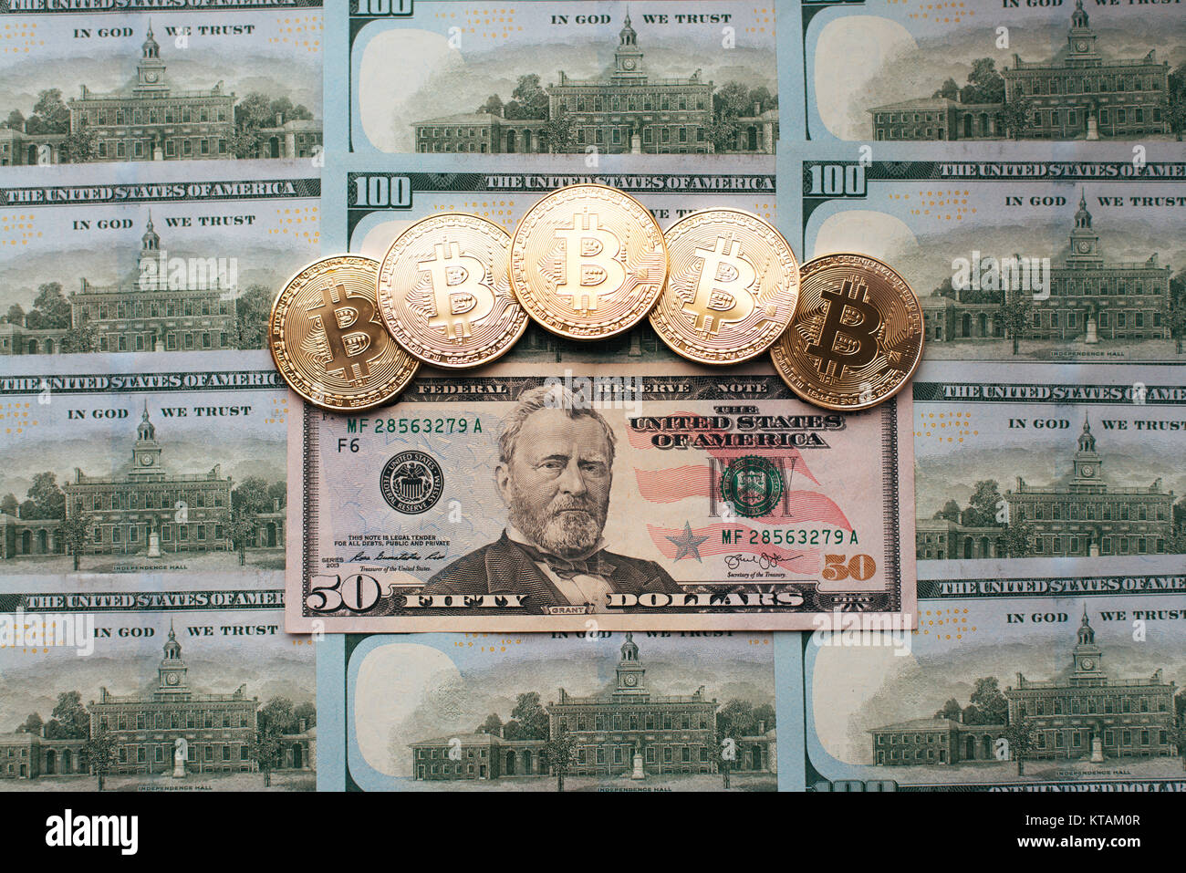 Coins bitcoin, the money lies, on the bill table of 50 dollars. The  banknotes are spread on the table in a free order of 50 dollars. Gold coins  are cr Stock Photo - Alamy