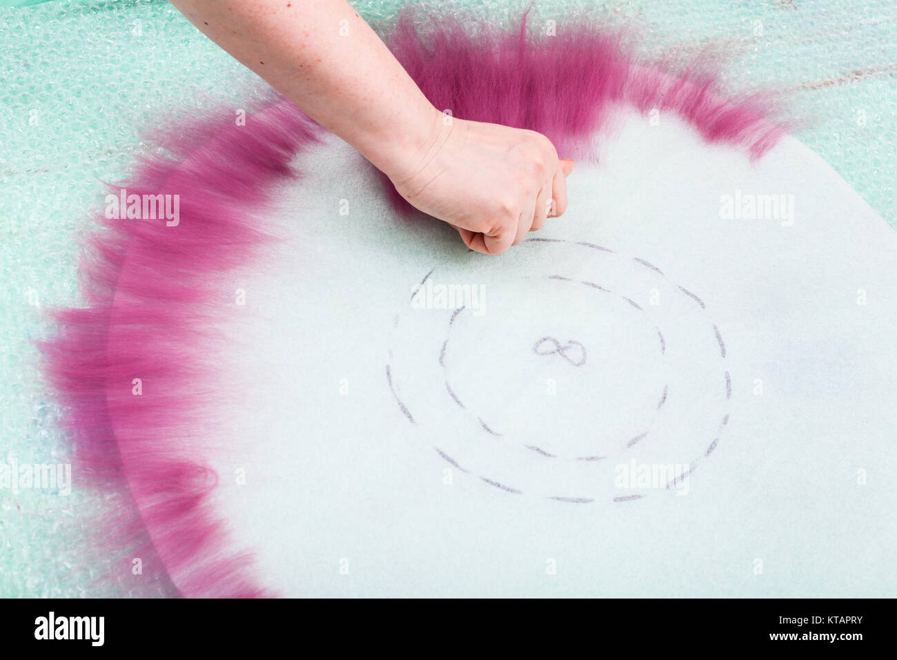 hatter spreads first layer of fibers on pattern Stock Photo - Alamy