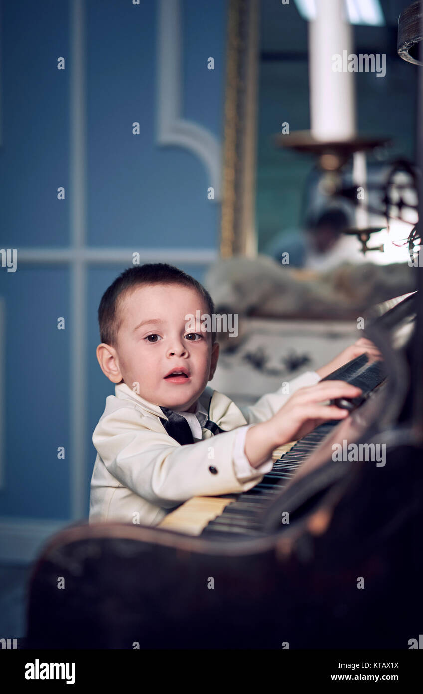 child plays the piano Stock Photo