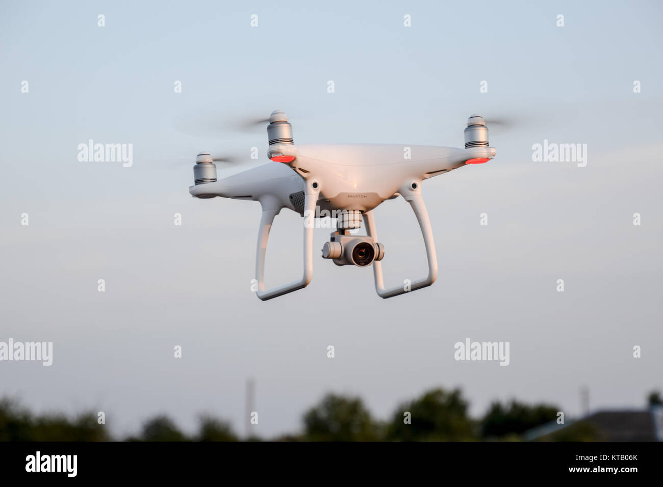 The drone, hovering in the air against the treetops Stock Photo Alamy