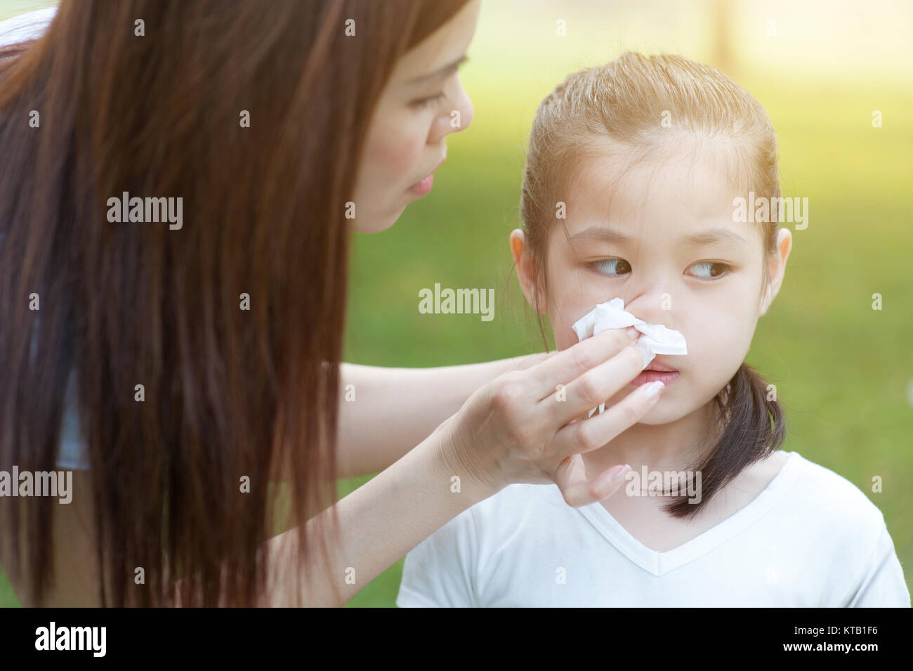Flu season, little girl blowing nose. Stock Photo