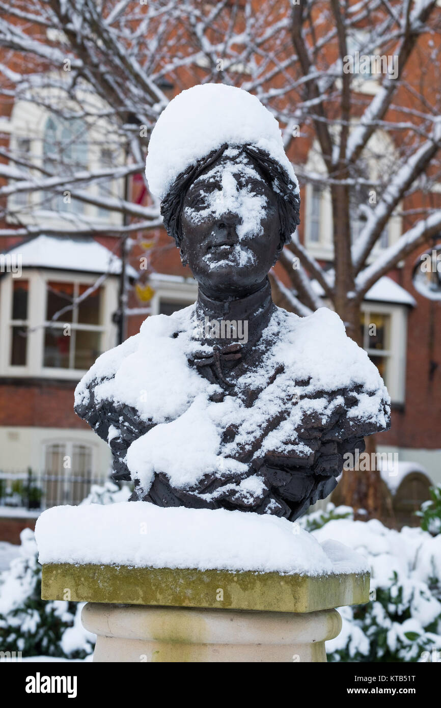 Bronze bust of the novelist Mary Webb covered in snow outside Shrewsbury Library, Shropshire, England, UK Stock Photo