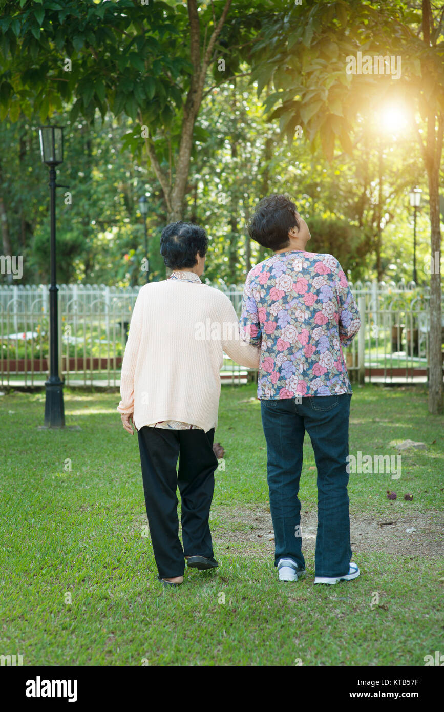 Rear view Asian elderly women walking in park Stock Photo - Alamy