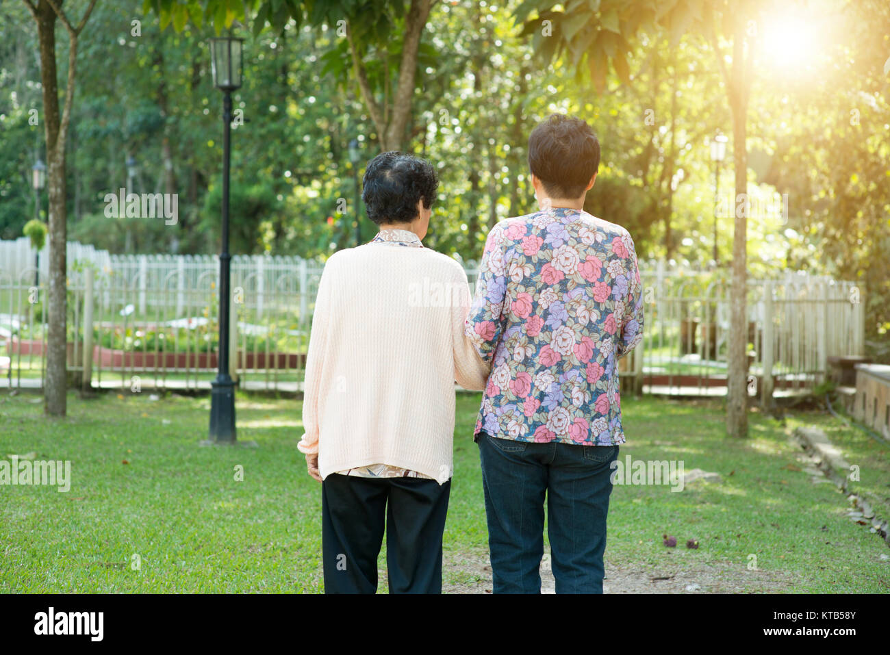 Rear view Asian elderly women walking in garden park Stock Photo - Alamy