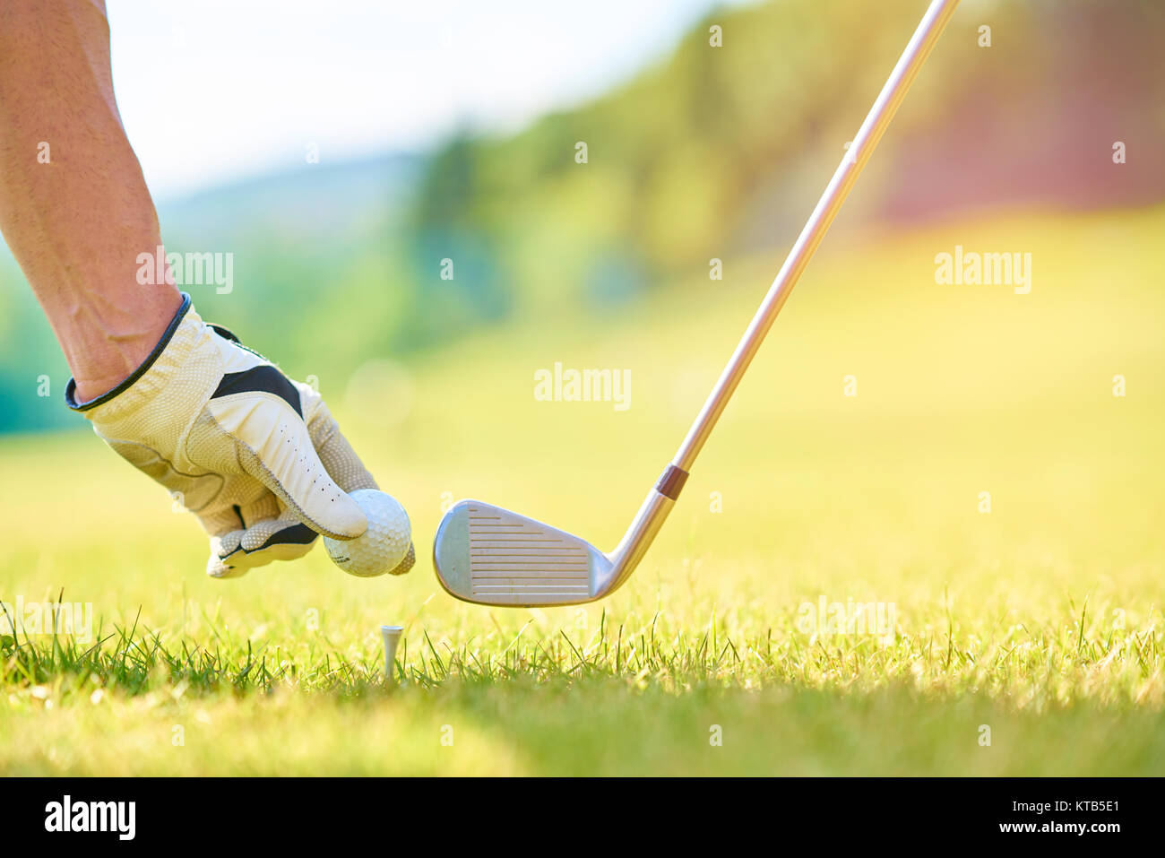 Young person playing golf on a sunny day Stock Photo
