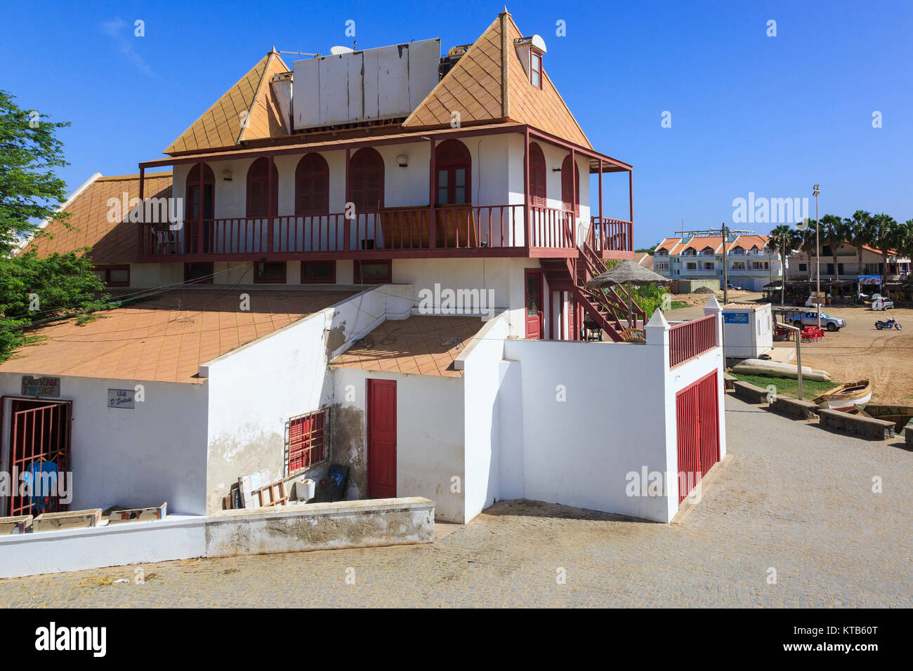 Original lighthouse building which has been converted into houses at the end of the pier at Santa Maria, Sal Island, Cape Verde, Africa Stock Photo
