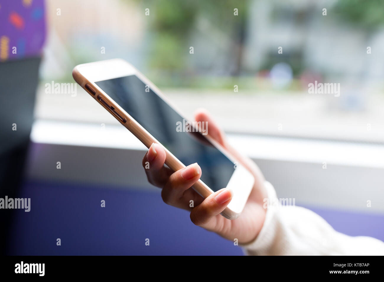 Woman use of mobile phone inside bus of Hong Kong Stock Photo - Alamy