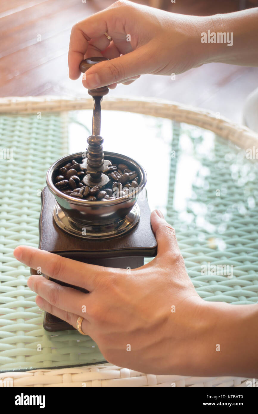 Hand On Grinding Roasted Coffee Stock Photo Alamy