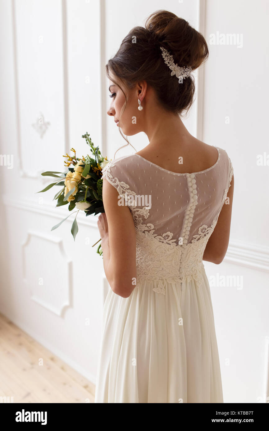 Portrait of the bride in a wedding dress with a bouquet Stock Photo - Alamy