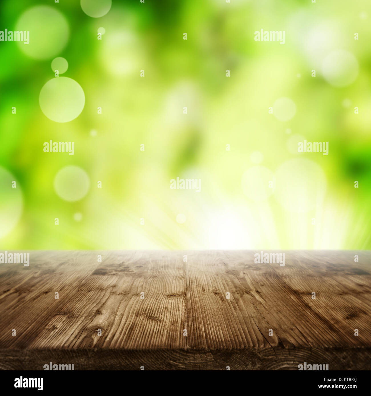Abstract radiant green spring background with empty wooden table for a concept Stock Photo