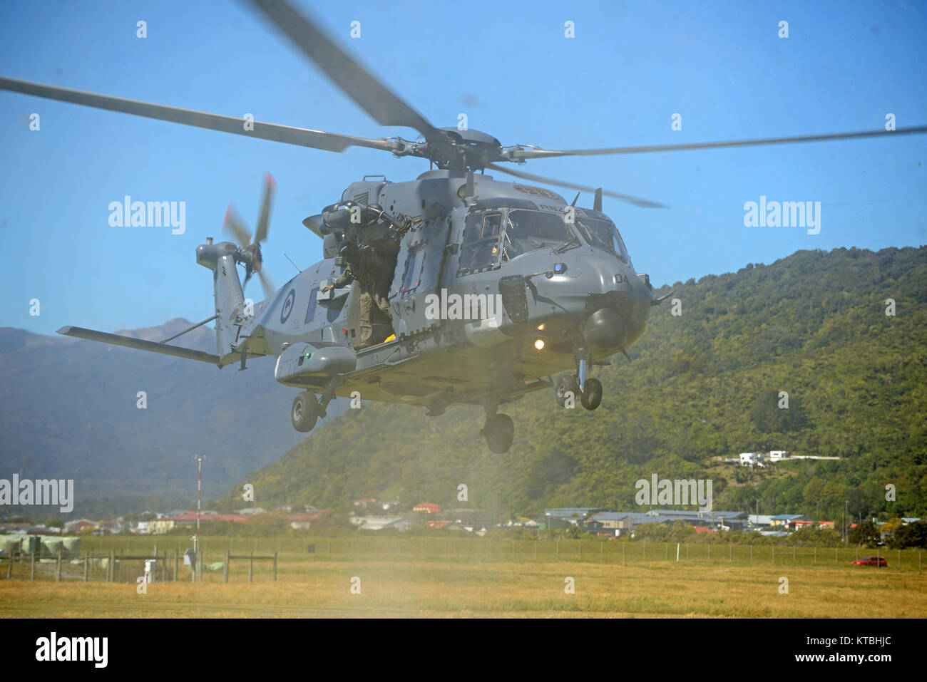 GREYMOUTH, NEW ZEALAND, NOVEMBER 18, 2017: Dust and flying debris obscure an Air Force NH90 helicopter taking off at an open day run by the New Zealand armed forces. The NH90 was built by NATO Helicopter Industries (NHI) (France). Stock Photo