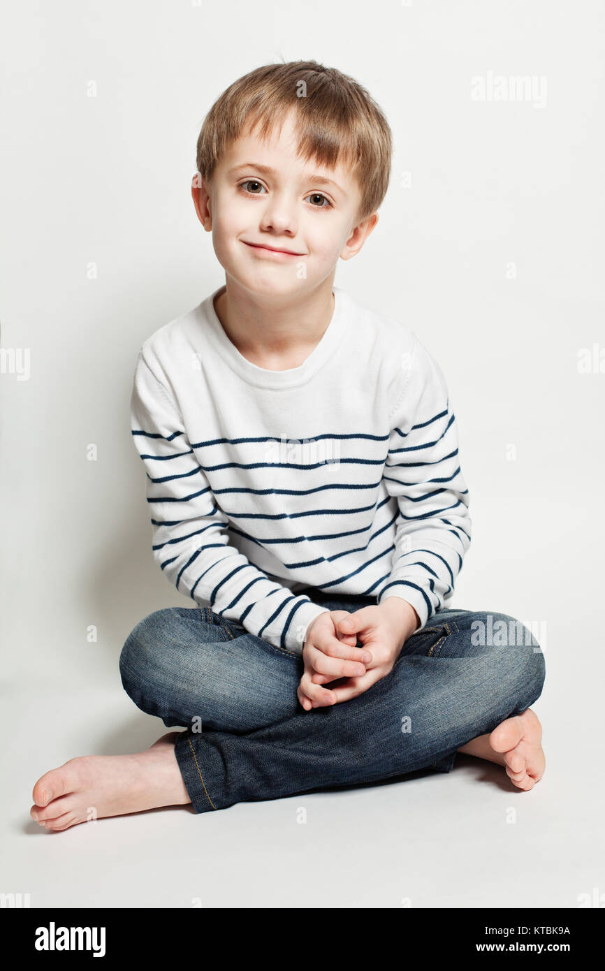 Cute little boy sitting on the floor Stock Photo Alamy