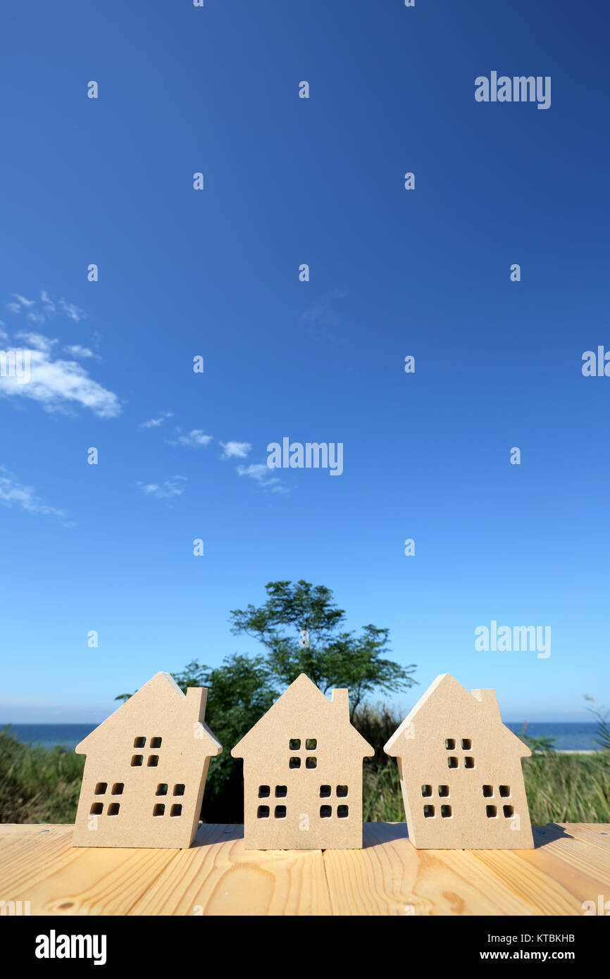 Miniature model of house with blue sky background Stock Photo - Alamy