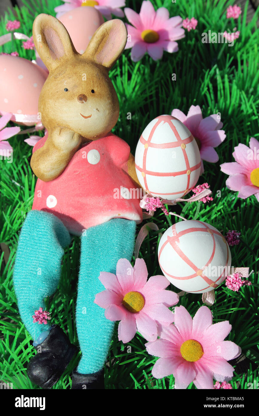 lying easter bunny with colorful eggs on a flower meadow Stock Photo ...