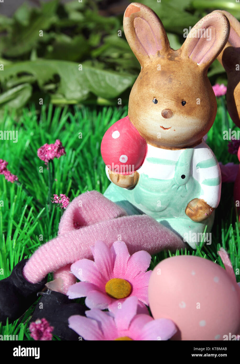 easter bunny with colorful eggs in a meadow Stock Photo - Alamy
