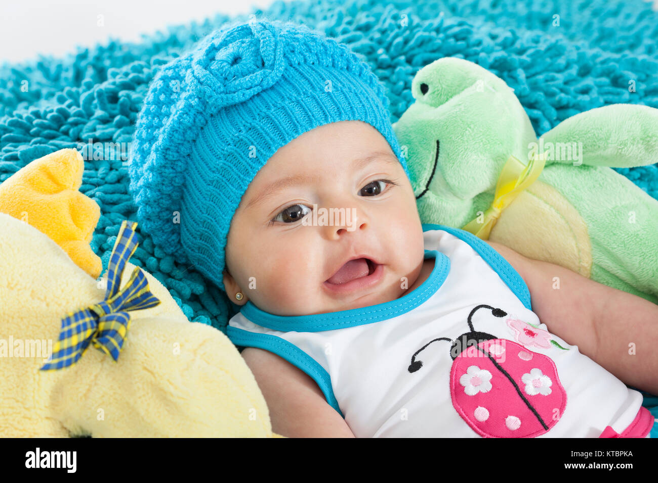 Four months old baby girl wearing a blue cap Stock Photo