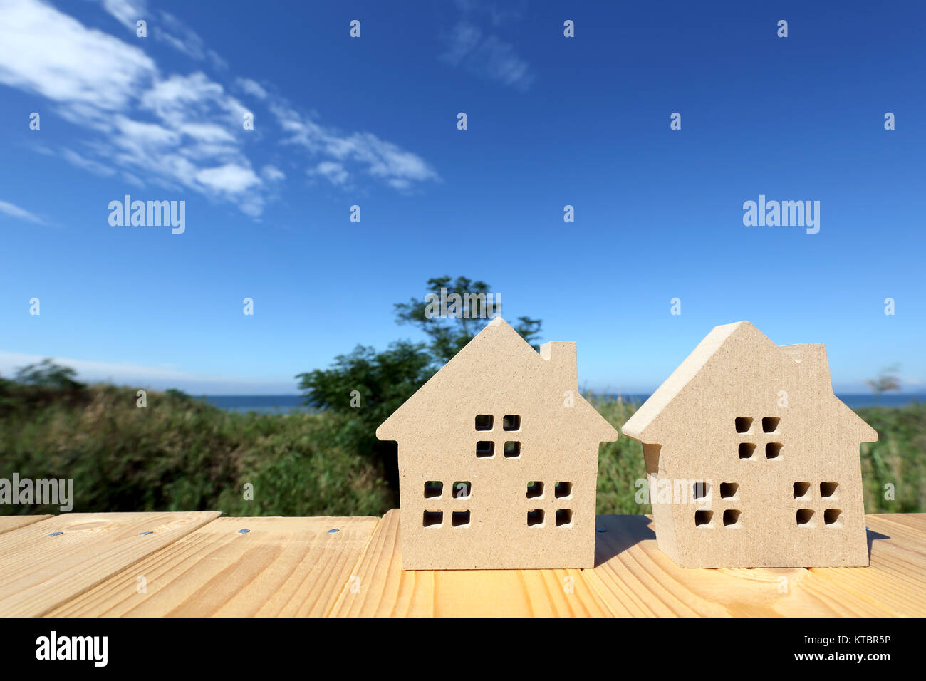 Miniature model of house with blue sky background Stock Photo - Alamy