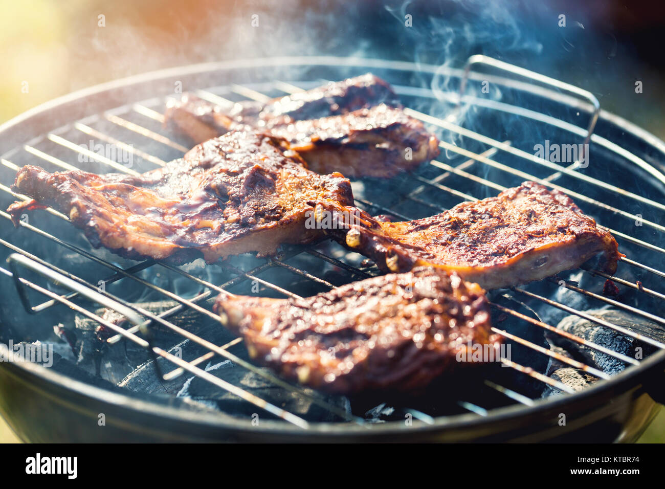 american barbecue preparing beef ribs on charcoal grill Stock Photo