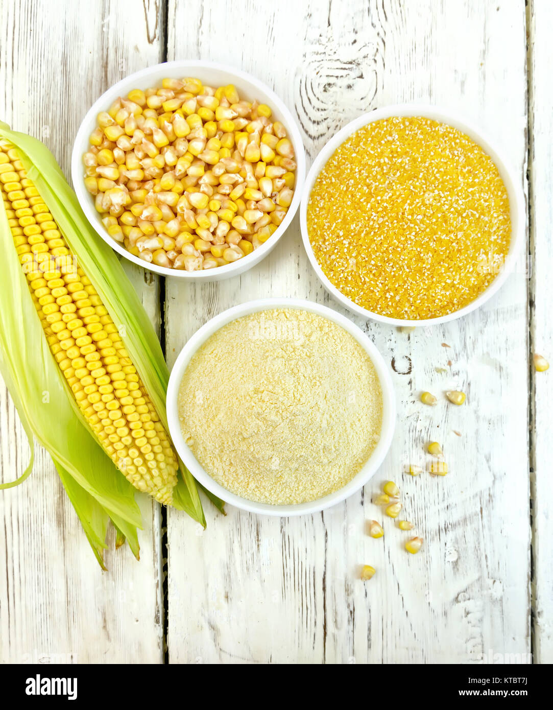 Flour and grits corn in bowls with cobs on board top Stock Photo Alamy