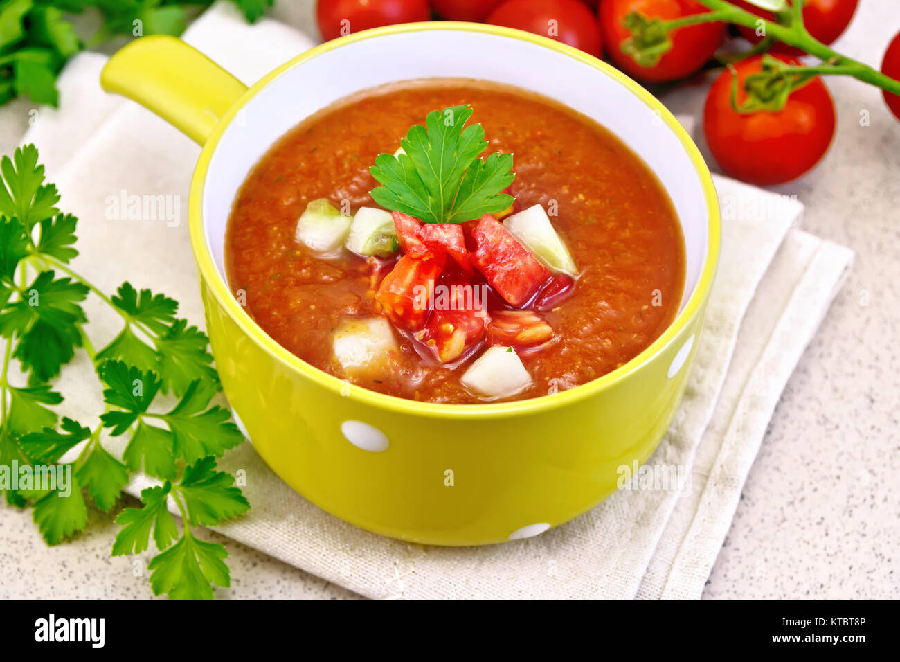 Soup tomato in yellow bowl on stone table Stock Photo - Alamy