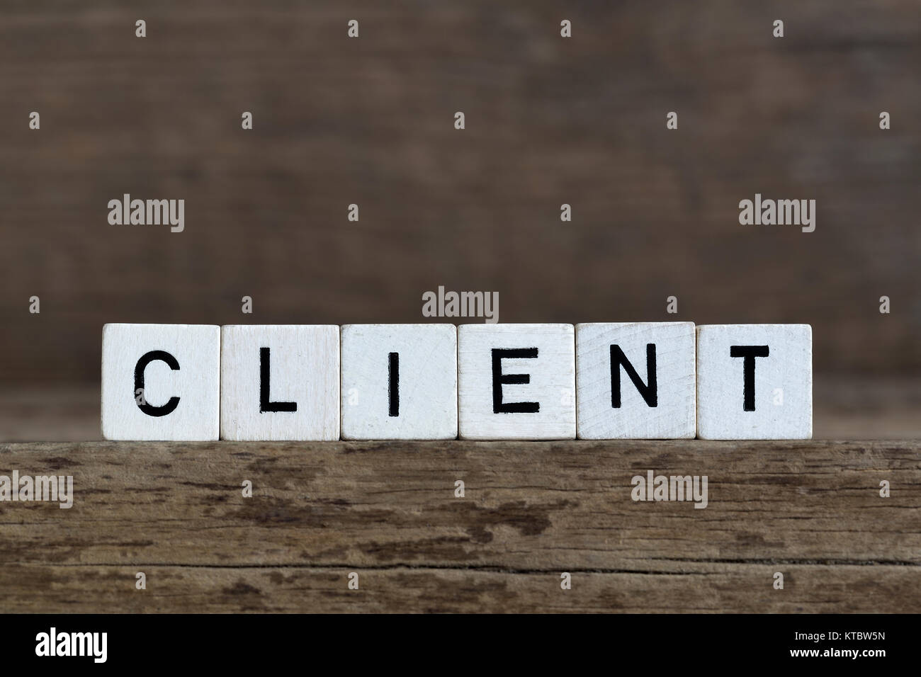 Client, written in cubes on a wooden background Stock Photo - Alamy
