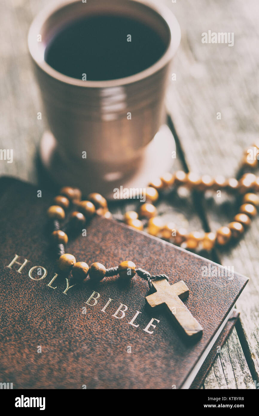 Rosary beads, holy bible and cup of wine Stock Photo Alamy