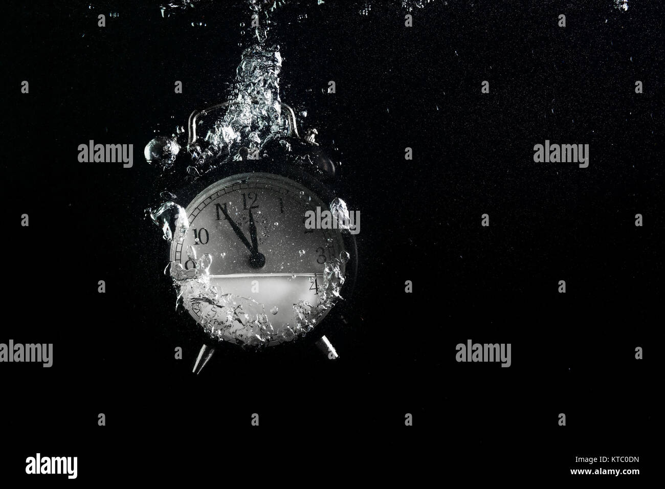 Alarm clock in water Stock Photo Alamy