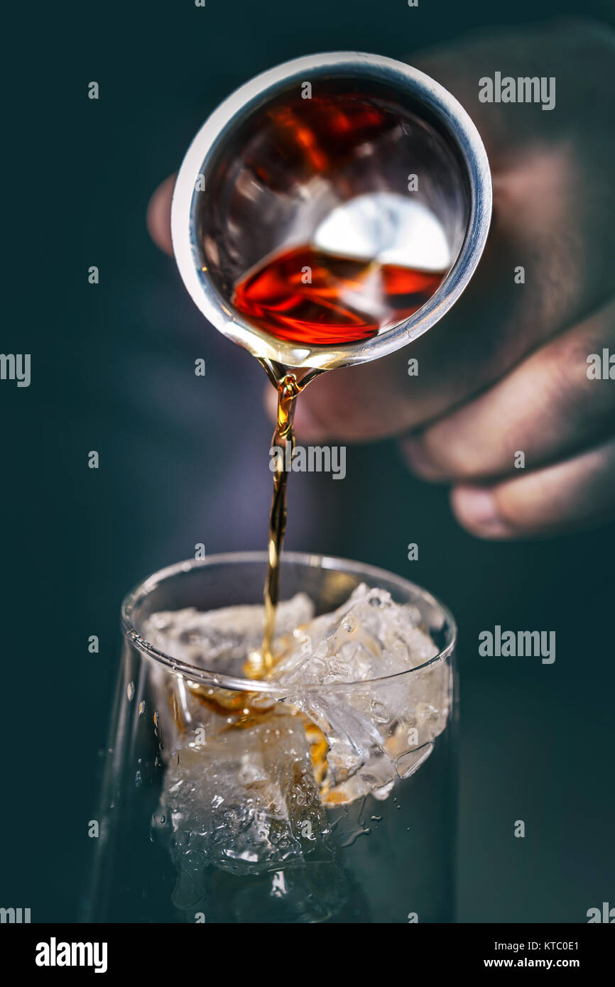 Pouring alcohol from a measuring glass Stock Photo Alamy