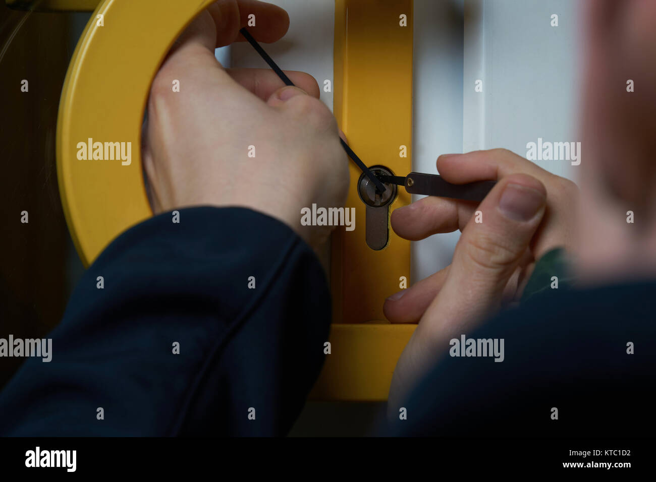 Intruder Or Burglar With Lockpick Tool Opens The Front Door