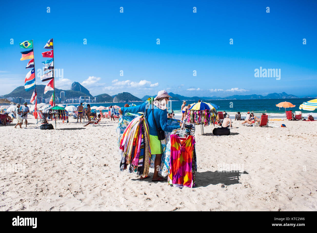 RIO DE JANEIRO, BRAZIL - APRIL 24, 2015: Brazilian street vendor sells table cloths on April 24, 2015 at Copacabana Beach, Rio de Janeiro. Brazil. Stock Photo