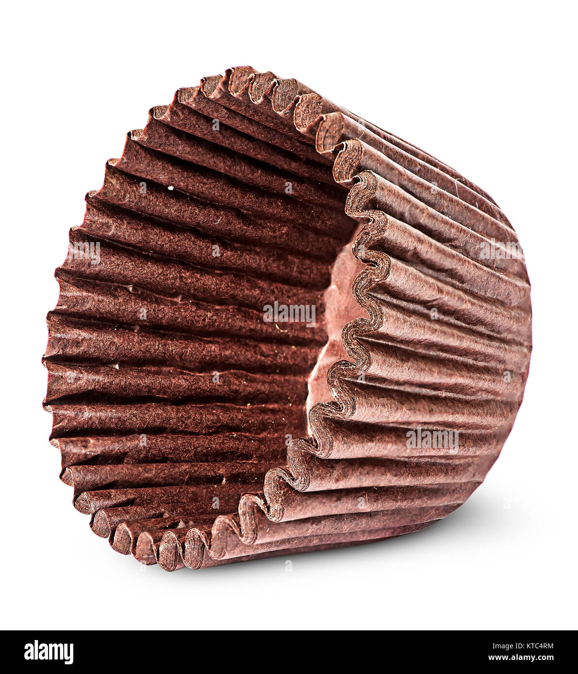 Stack of brown paper cups for baking muffins on the side Stock Photo
