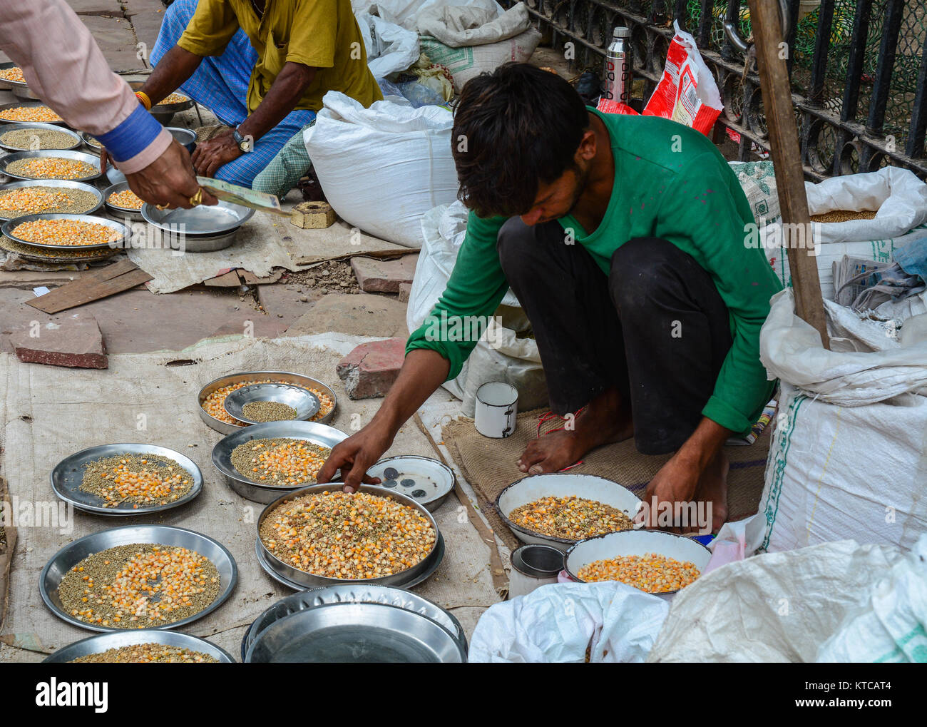 Delhi, India - Jul 26, 2015. Vendors selling bird foods at the old market in Delhi, India. According to the 2011 census of India, the population of De Stock Photo
