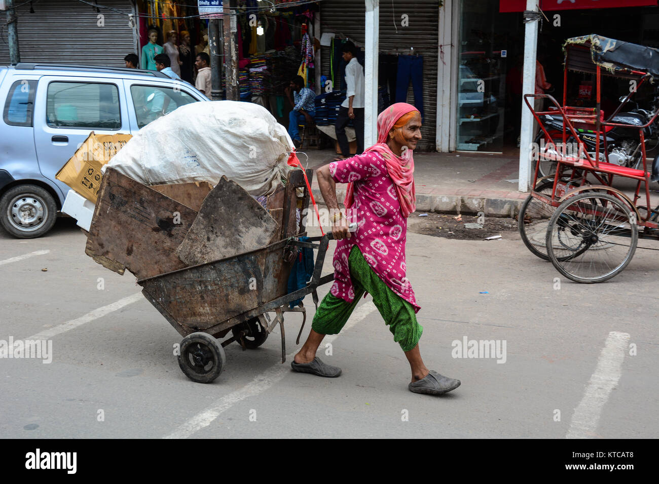 Delhi, India - Jul 26, 2015. A woman carrying goods at the old market in Delhi, India. According to the 2011 census of India, the population of Delhi  Stock Photo