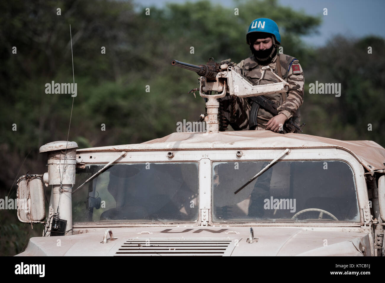A UN peacekeeper provides protection for a convoy enroute to Faradje in the northern DRC, through areas where the Lords Resistance Army is operational Stock Photo