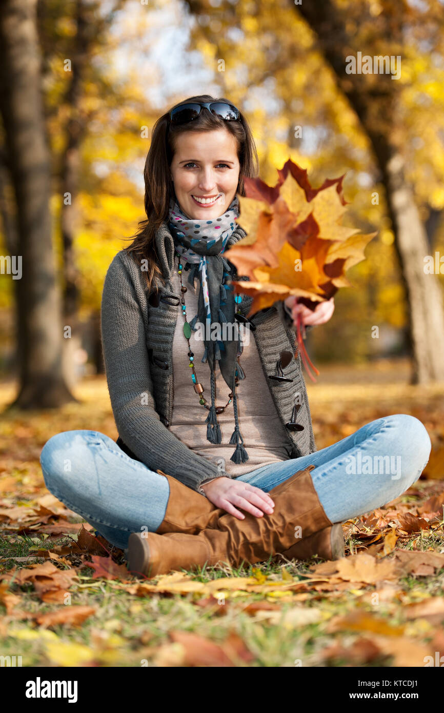 Young woman with autumn leaves in hand Stock Photo - Alamy