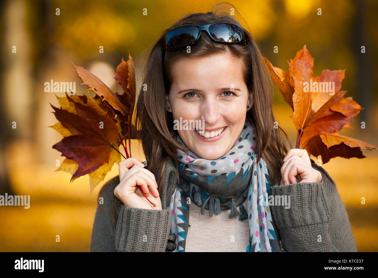 Young woman with autumn leaves in hand Stock Photo - Alamy