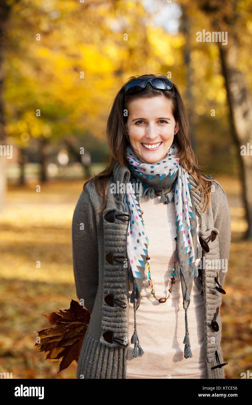 Young woman with autumn leaves in hand Stock Photo - Alamy