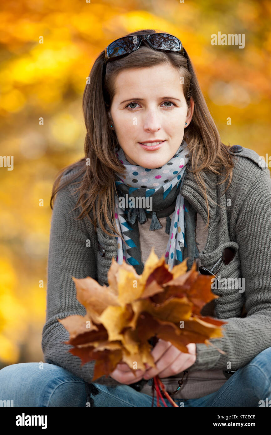 Young woman with autumn leaves in hand Stock Photo - Alamy