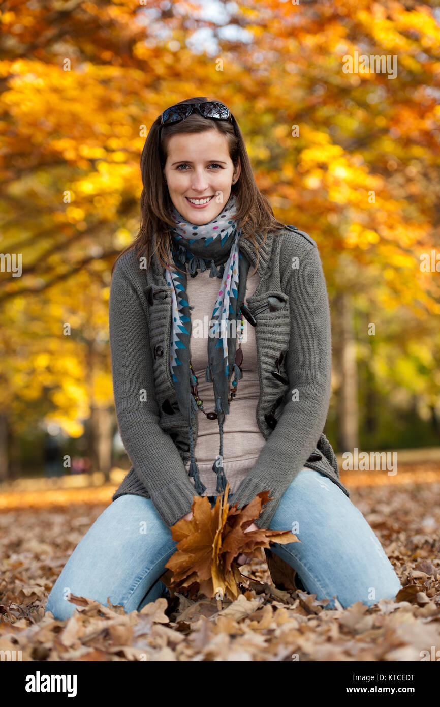 Young woman with autumn leaves in hand Stock Photo - Alamy