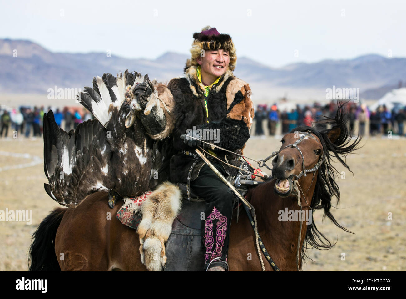 Kazakh eagle hunter on horseback during Golden Eagle Festival in Mongolia Stock Photo