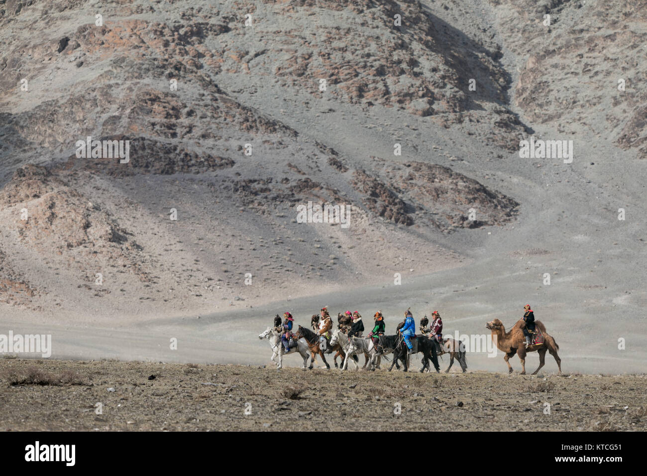 Kazakh eagle hunters arrive on horseback to the Golden Eagle Festival in Mongolia Stock Photo