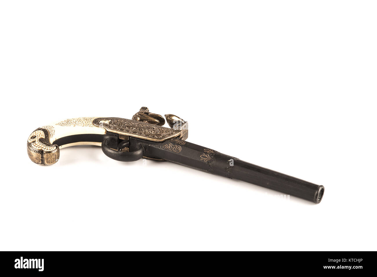 Flintlock pistol with engraved handle over a white background Stock Photo