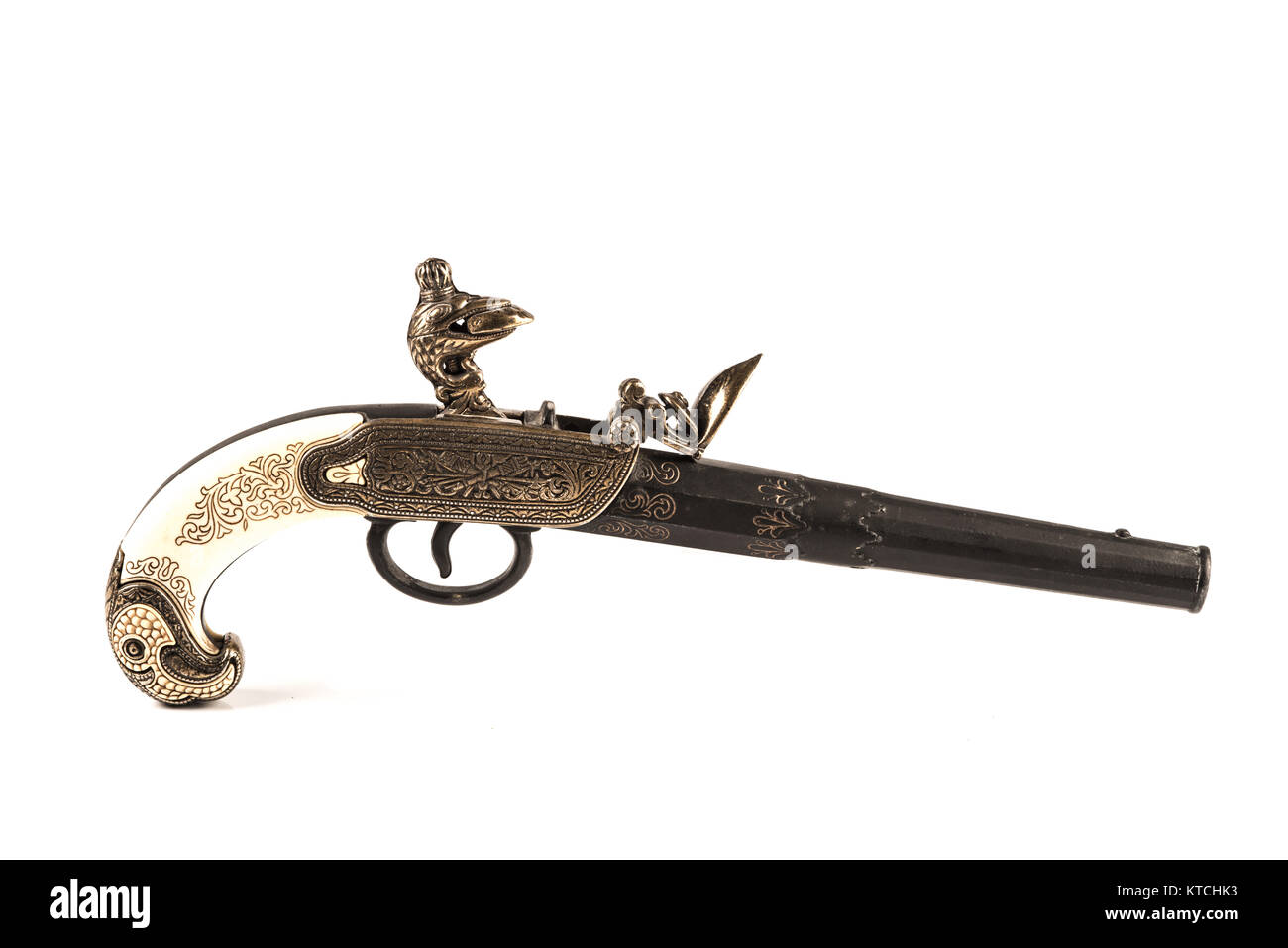 Flintlock pistol with engraved handle over a white background Stock Photo