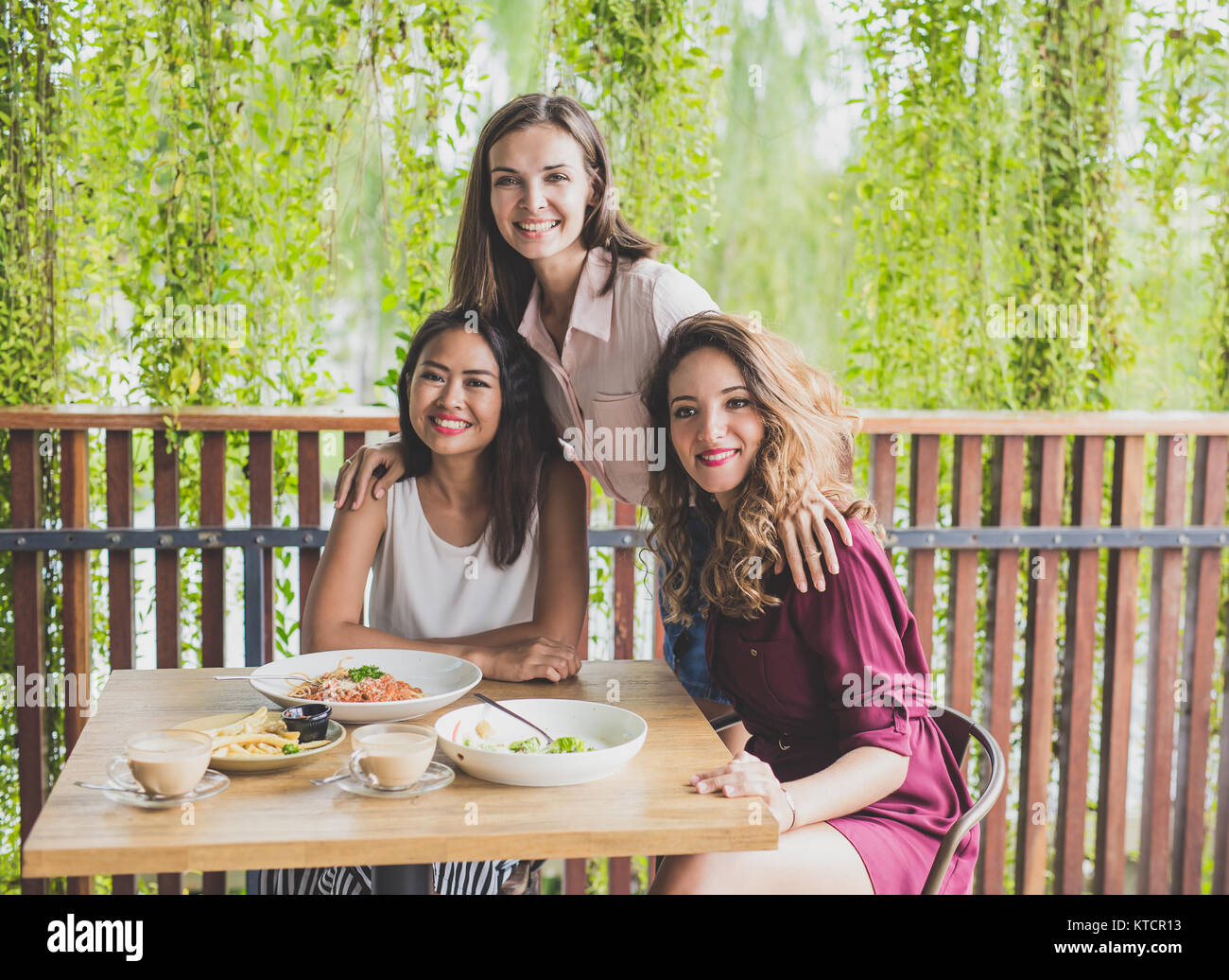 group of three best friend having their lunch together at a cafe Stock Photo Alamy