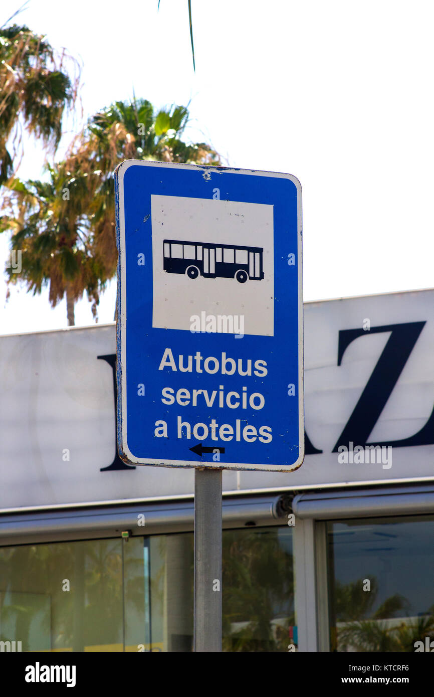 A rectangular metal bus stop sign with a blue reflective surface for complimentary hotel bus services in Albuferia Portugal Stock Photo