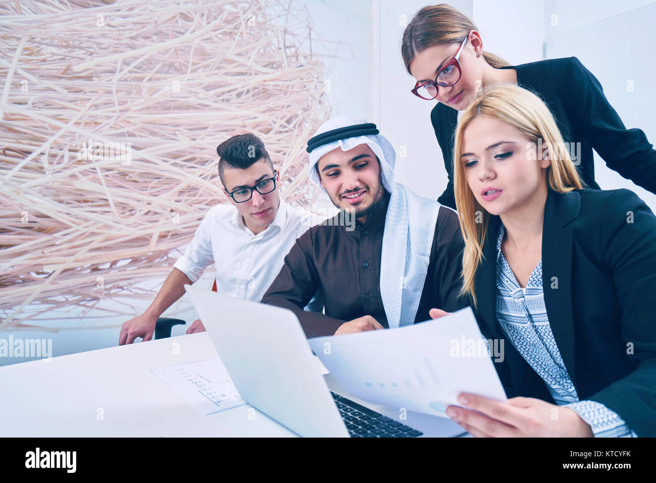 business people group on meeting and presentation in bright modern office with construction engineer architect and worker looking building model and b Stock Photo