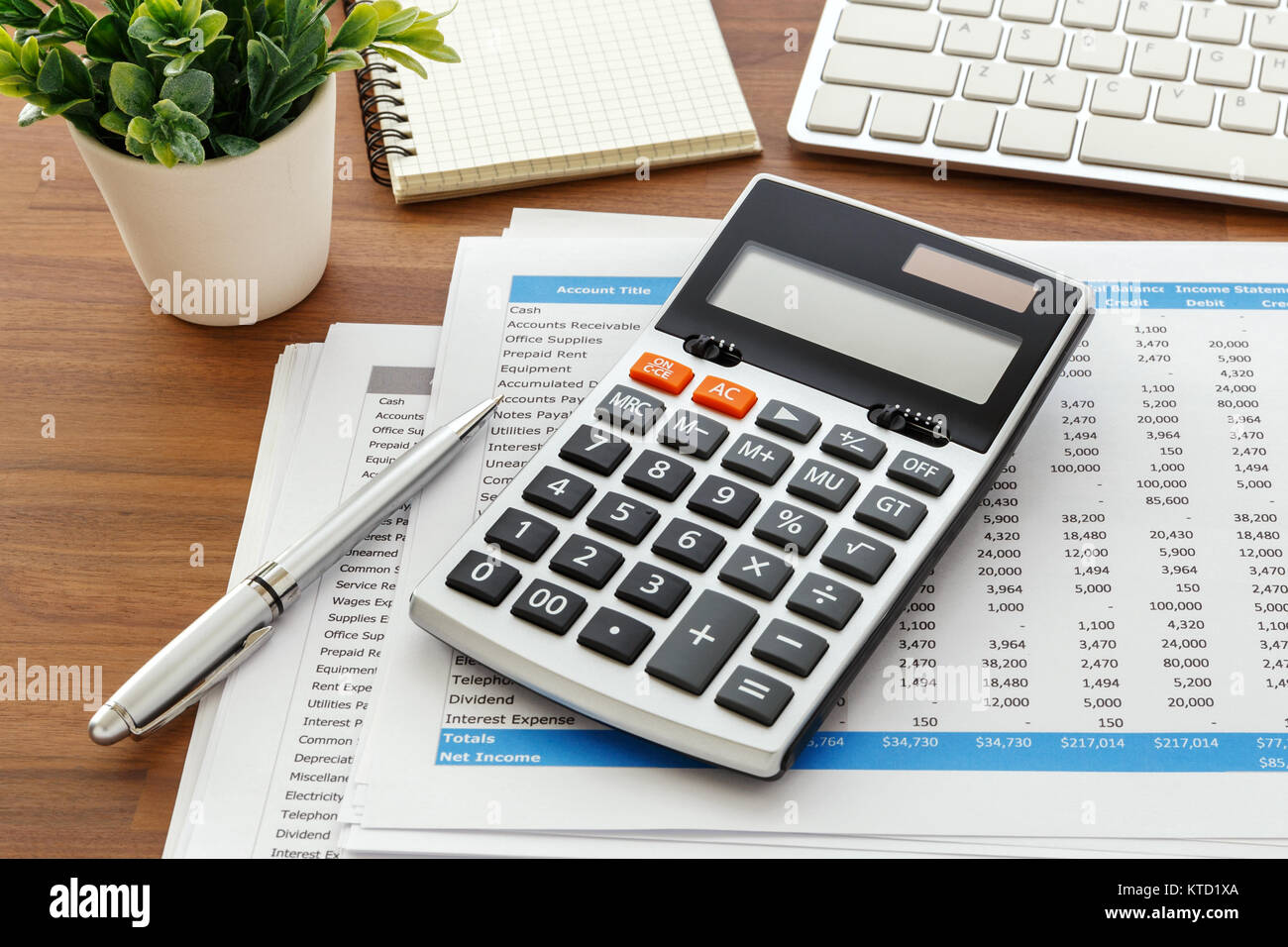 Financial accounting with calculator and accounting data on wooden table  Stock Photo - Alamy